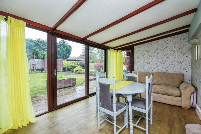 Flowing seamlessly from the lounge is this eyecatching dining room, which includes double-glazed patio doors leading to the back garden. It has a vinyl floor and wall lights.