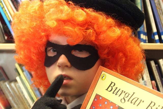 Katy Phipps, dressed as Burglar Betty, steals off with her favourite book at Wigley Primary School, near Old Brampton, in 2007.