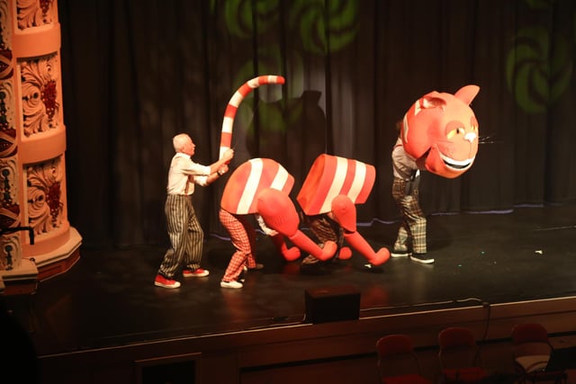A disembodied Cheshire Cat prowls the stage in Wise Owl Theatre Company's The Adventures Of Alice In Wonderland.