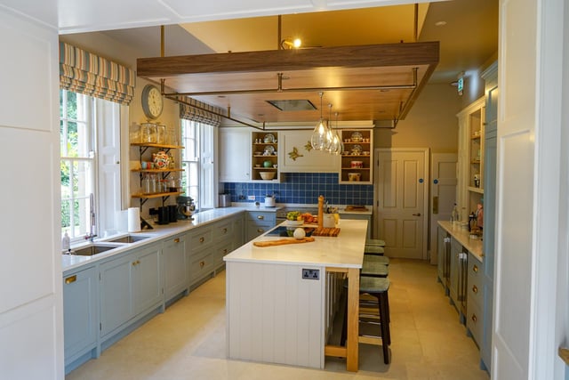 The large kitchen is stocked with four ovens, countless fridges and umpteen shelves heaving with Royal Doulton China, poised for a feast.