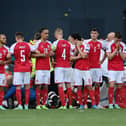 Denmark players surrounded teammate Christian Eriksen while he received CPR.