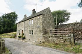 The stone built farmhouse sits in a quiet, rural location on Slack Lane, Ashover.