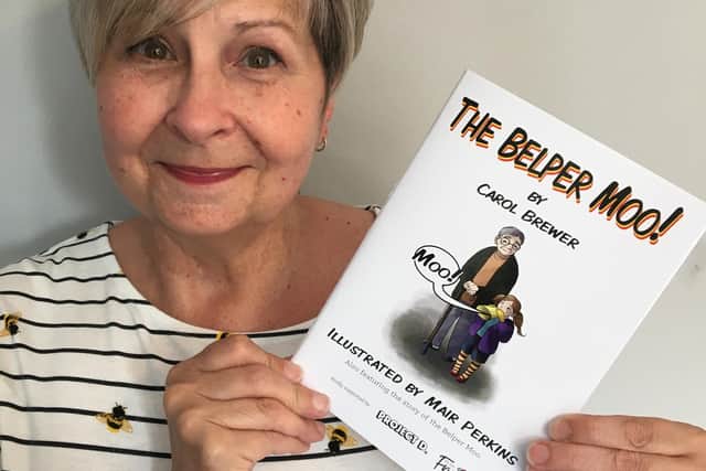 Carol Brewer with The Belper Moo! book.