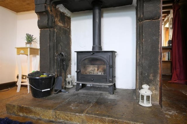 This wood burning stove sitting on a stone hearth with carved stone surround is a focal point of the lounge.