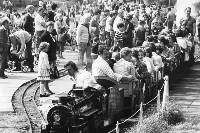 Bank Holiday crowds at the South Marine Park in August 1980. They are watching as a steam engine takes another load of passengers for a trip around the lake.