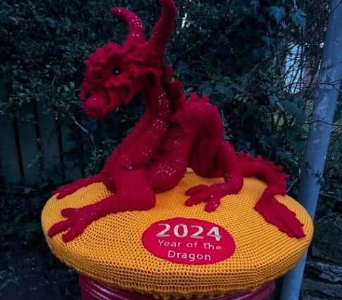 Margaret Upton crocheted this red dragon topper which brightens up a postbox in Ticknall.