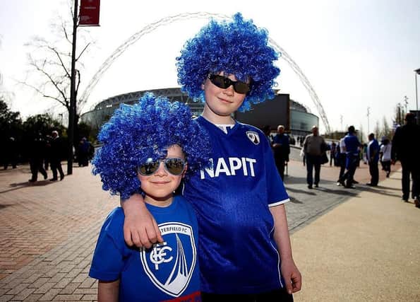 Young Chesterfield fans make their way to the stadium prior to the Johnstone's Paint Trophy Final between Chesterfield and Peterborough United at Wembley Stadium on March 30, 2014.
