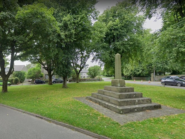 Thee obelisk-style market cross lies at the top of a set of steps on Litton's village green.