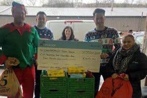 Fortem's team of elves presents cheque to Chesterfield Foodbank