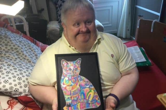 Shaun Gratton with one of the pictures that he is selling for Ashgate Hospice which helped him in his recovery from testicular cancer.