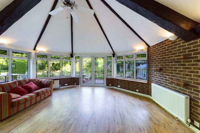The substantial conservatory offers a panoramic view of the large garden which surrounds the house.