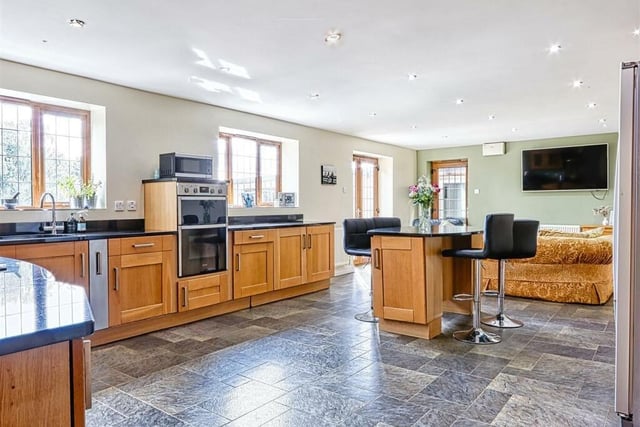 The well equipped and well appointed kitchen diner has wall and base units with granite worktops/upstands incorporating an inset sink, five ring gas hob, double oven and dishwasher. There is a four seater island breakfast bar. French doors lead out to the rear garden.