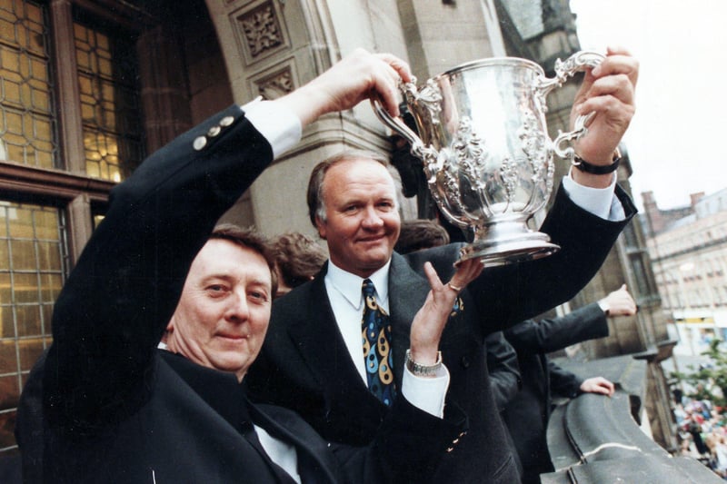 Chairman Dave Richards and manager Ron Atkinson celebrate the achievement.