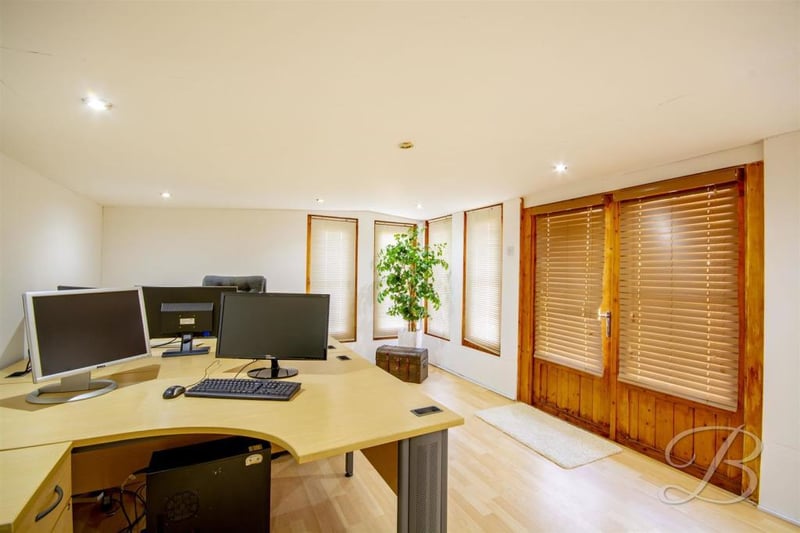 The annexe even has its own office. It has laminate flooring, windows and patio doors leading outside.