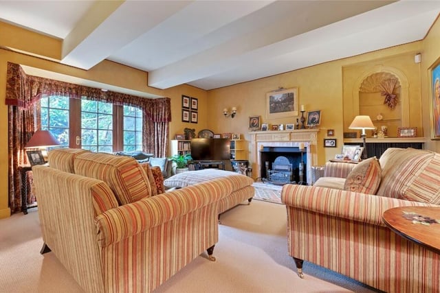 The comfortable sitting room has an open fire.