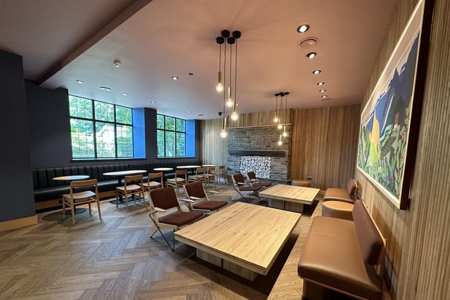 While the design of the café is modern, wooden flooring, wall panels and tables create a cozy atmosphere.