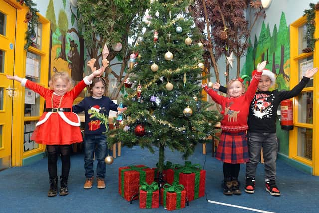 Christmas celebration at Shirebrook Park Schools Federation. Children from year 1 in the decorated entrance. The children are: Evelyn Pittaway,
Patrick Cech, Harry Dalby and Courtney-Mae Roberts.