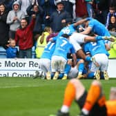 Andrew Dallas gets swamped by his teammates as he celebrates his matchwinning goal for the Spireites against Eastleigh. Picture: Tina Jenner.