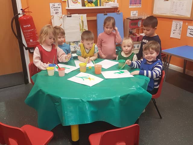 The children at Tideswell Preschool painting daffodils and celebrating their good Ofsted rating. Photo Tideswell Preschool
