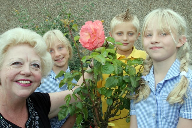 Hady school teacher Judith Sensecall retired after 32 years.  She is pictured with Lauren Andrews, Kyle Perrins and Katherine Andrews who were all 10 when this photo was taken in 2006.