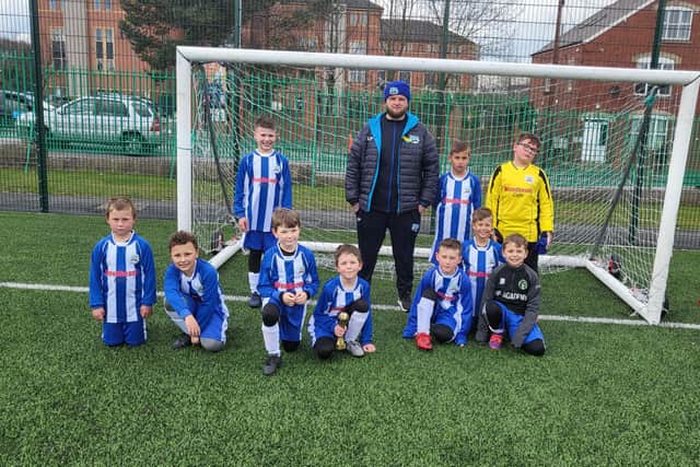 Some of Brimington Little Stars' players are pictured with coach Lewis Preece.