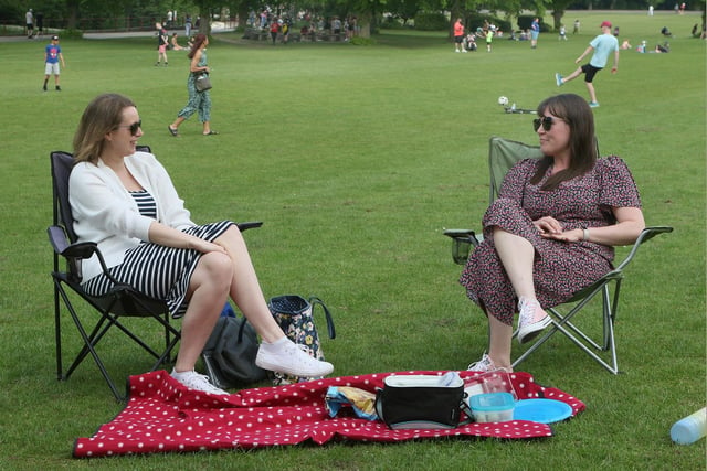 Friends enjoy a picnic in Queen's Park.
