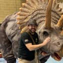 Head ranger Chris Roberts and one of the animatronic dinosaurs.