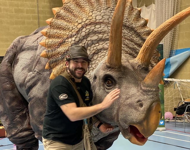 Head ranger Chris Roberts and one of the animatronic dinosaurs.