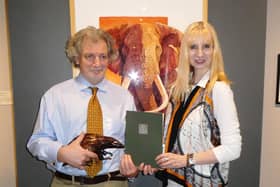 Anna-Louise Pickering presents the award to Douglass Lockyer in front of his winning painting.