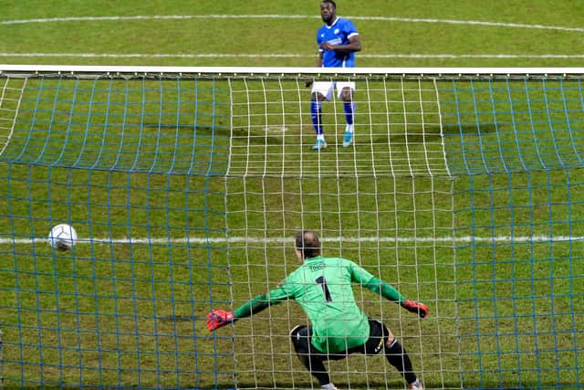 Akwasi Asante slots his penalty into the net in the shootout win.