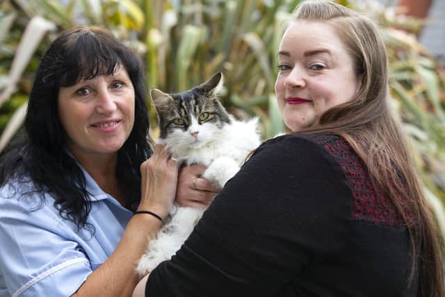 Staff members Mandy Burrell and Katie Thornley with Milo, the resident cat at Presentation Sisters Care Centre in Matlock (photo: Lucy Ray/PA Wire).