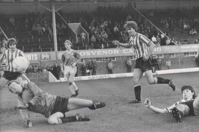 Bob Newton tussle for the ball in goal mouth scramble against Exeter on 20th October 1984. Spireites finished the campaign with just one home defeat on their way to lifting the title.