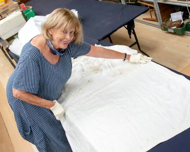 Hansons’ period clothing consultant Notty Hornblower measures the width of Queen Victoria’s nightdress.