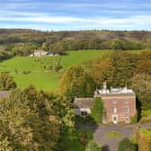 The stunning country house is set in formal gardens with views of the Peak District beyond.