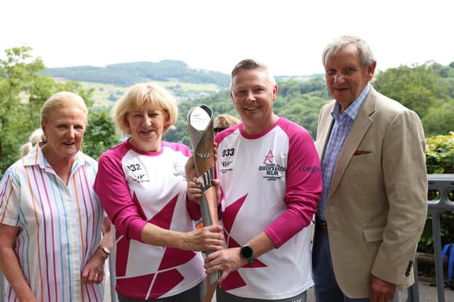 Andrew and Vanessa Pugh welcome the Queen's Baton to the Heights. Photo: Steven Braithwaite.