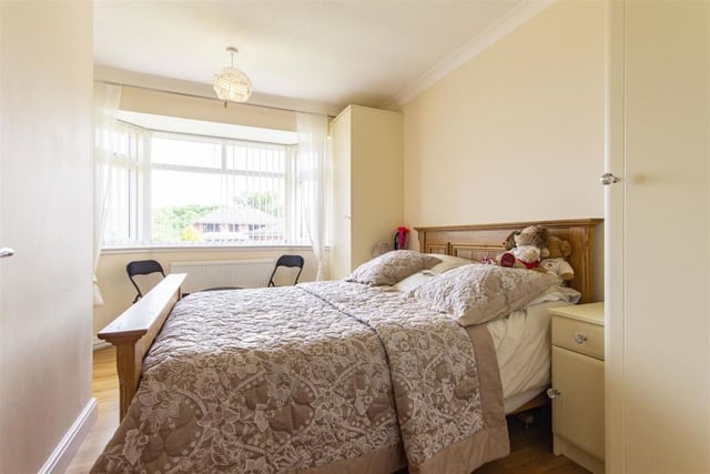 Two of the four bedrooms at the dormer bungalow can be found on the ground floor, including this one. It contains two fitted single wardrobes and matching bedside cabinets, while the large bay window faces the front of the property.