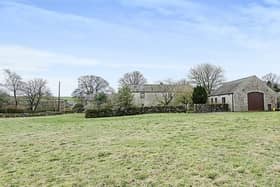 The property comprises three-bedroom house, separate converted barn that is currently used as a garage and office, generously proportioned gardens and a field.