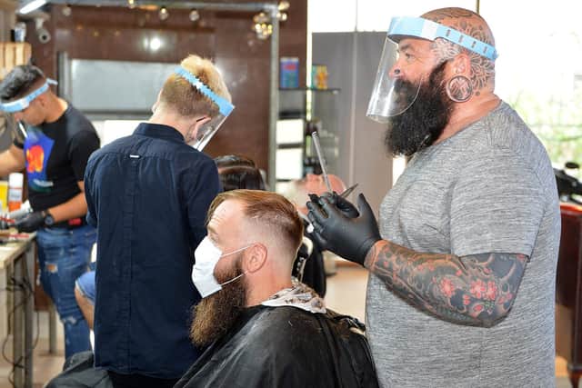 Martin Wallis-Keyworth at work at Less Than Zero Barbers earlier this year. Picture by Brian Eyre.