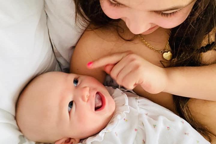 Katie Spencer, said: "Gorgeous Sienna Rose born 11/12/20 smiling at her big sister Brooke age 6. She also has 2 big brothers Jack 13 and Charlie 10. She has been lucky to spend so much time with them during lockdown and having them all at home everyday. Definitely some positives to homeschooling."