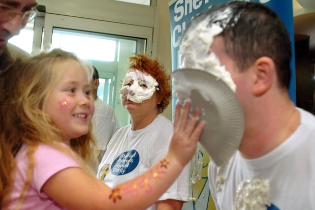 To mark 'Play in Hospital Week' in 2005, patients at Sheffield Childrens Hospital had the chance to throw custard pies at staff - Antonia Fox, then aged four, from Doncaster is pictured with Kevin Hartshorn, a play specialist.