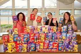 Claire Hollingshurst and Tracy Thompson from Lubrizol, with Jordan Hazell from Children First and Hannah Swanborough from Lubrizol, with the pile of Easter eggs donated by the company 