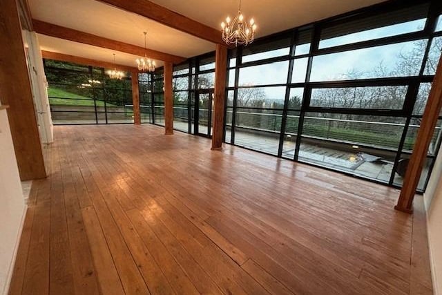 Wooden beams and flooring in this lovely reception room which enjoys a great view through the floor to ceiling windows.
