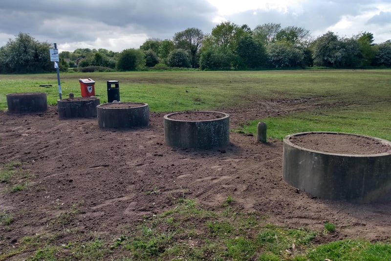 Concrete rings filled with soil have been installed across Spring Walk. The council will work with residents to have these planted and improve how they look.