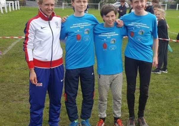 Sam Soles, Edward Diamond and Stuart Diamond from Chapel en le Frith High School get tips from Victoria Wilkinson, GB athletics international and national fell running champion.