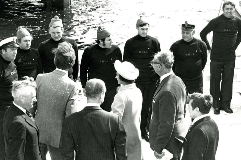 Queen Elizabeth II is pictured inspecting the crew of the Lifeboat "The Scout" in 1977.