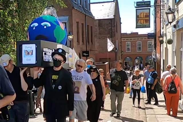 Extinction Rebellion protesters carried a coffin containing a model of a weeping Mother Earth through Chesterfield town centre on Saturday, July 17.