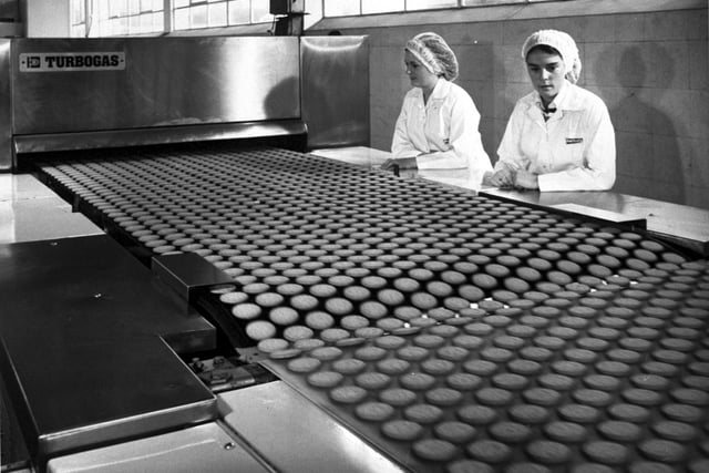 Women watch the biscuits on a conveyor belt at Burton's biscuit factory (Burton's Gold Medal Biscuits) on Calder Road, Sighthill industrial estate Edinburgh, in September 1978.