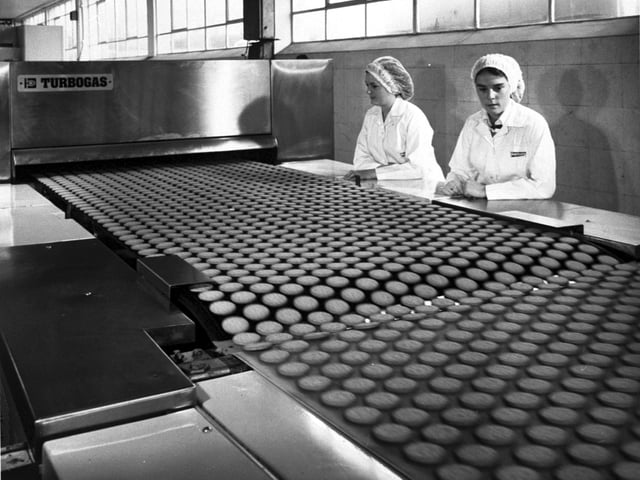 Women watch the biscuits on a conveyor belt at Burton's biscuit factory (Burton's Gold Medal Biscuits) on Calder Road, Sighthill industrial estate Edinburgh, in September 1978.