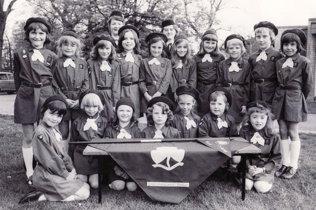 The presentation of the Pennant to the 2nd Hasland Brownies, Chesterfield, was held at the Hasland Youth Club tonight and our picture shows the pack with their pennant and leaders Mrs Janice Rodgers (left) and Mrs Mavis Harrison - 4th May 1976
