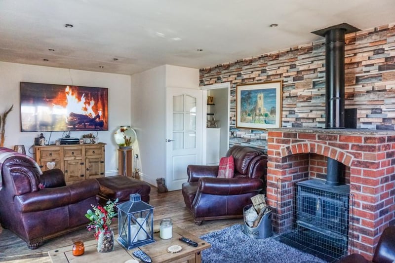 Spacious living room with feature multi fuel log burner.